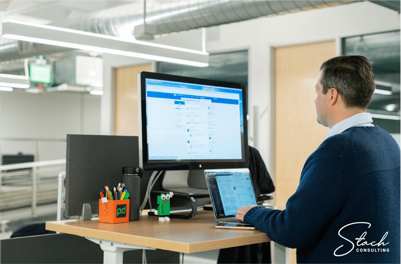 Business man navigating through his personal LinkedIn feed on a desktop computer.